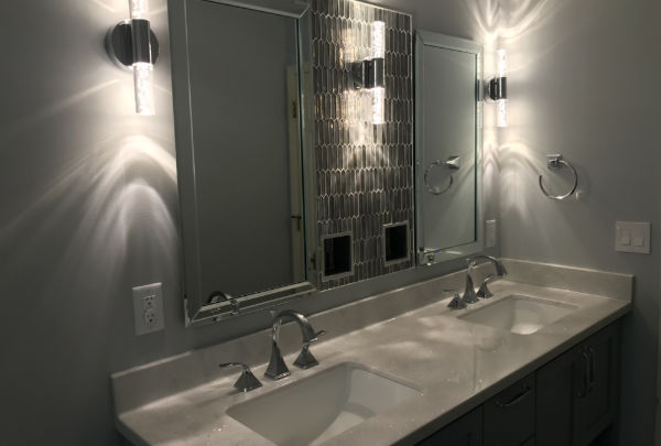 Remodeled guest bathroom with a tiled shower and custom vanity