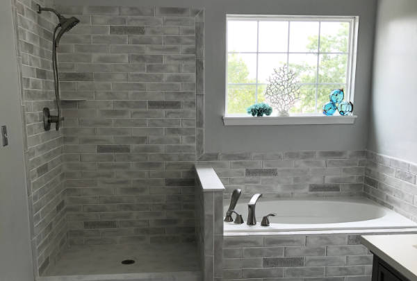 Bright remodeled bathroom with a tiled shower and vanity
