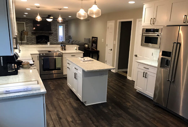 Remodeled kitchen with a centre island and hardwood flooring